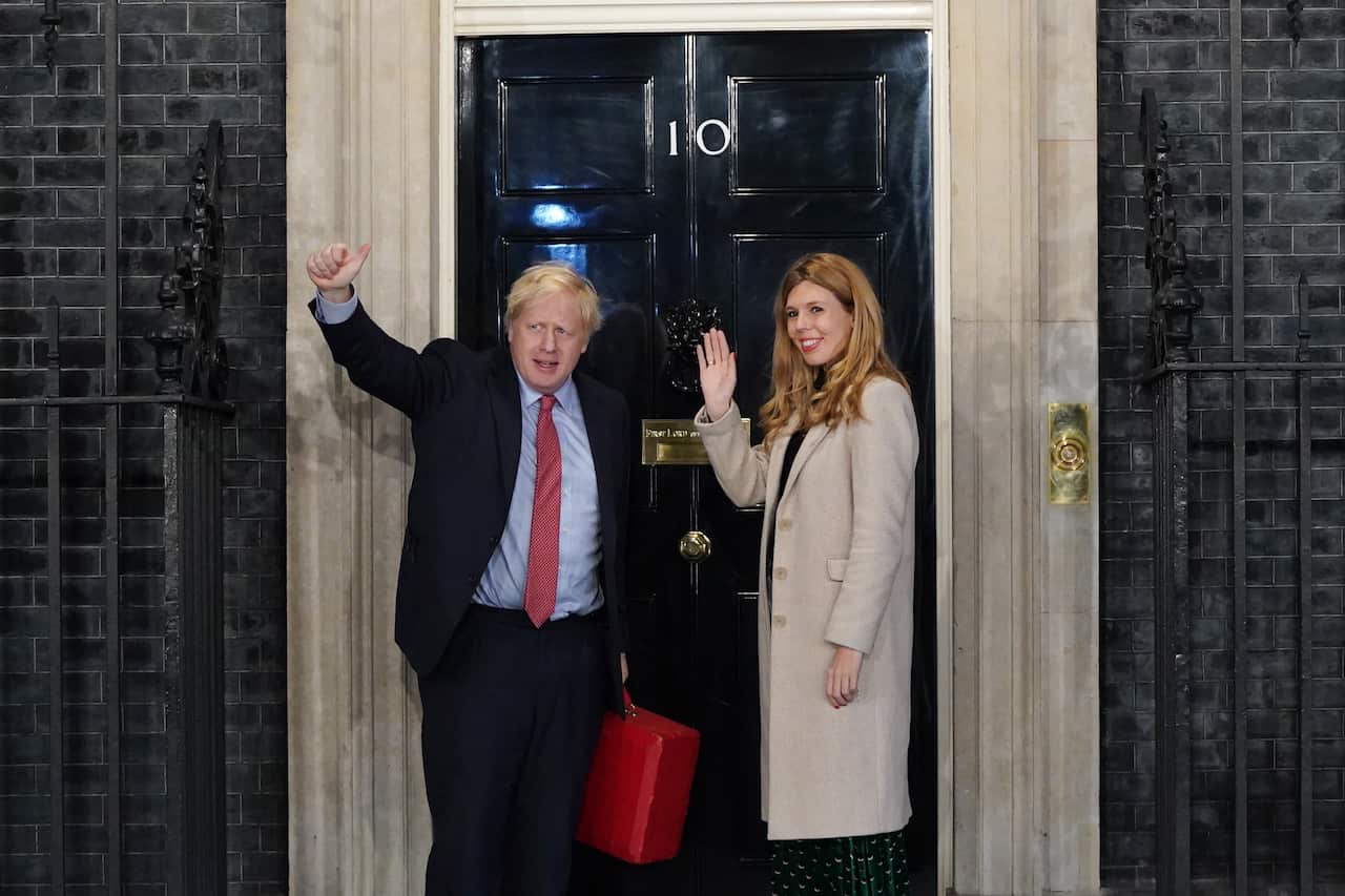 British Prime Minister Boris Johnson and his partner Carrie Symonds enter Downing Street.