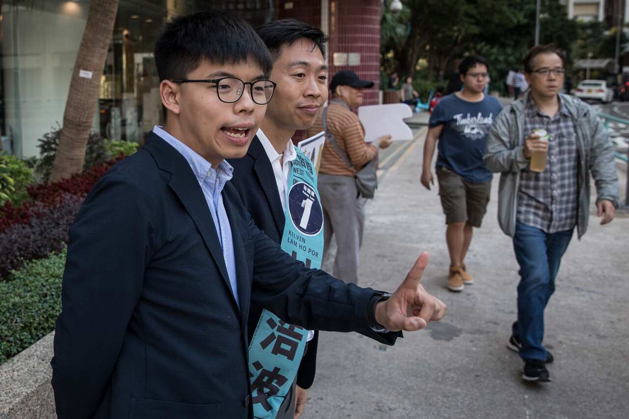 Joshua Wong (L) campaigns with his replacement candidate Kelvin Lam (R) in Hong Kong.