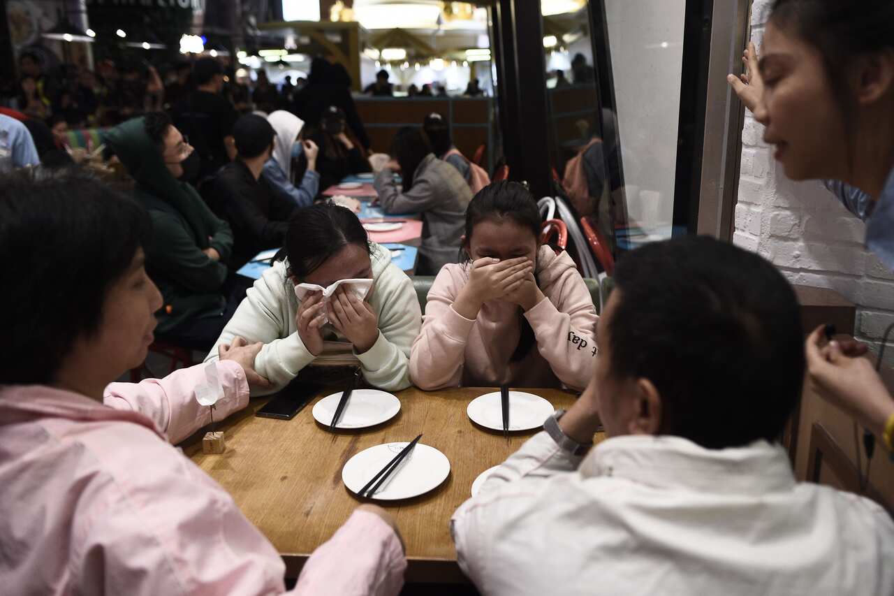 Restaurant customers (C) cry as people take part in a rally at the Langham Place shopping mall in Mong Kok.