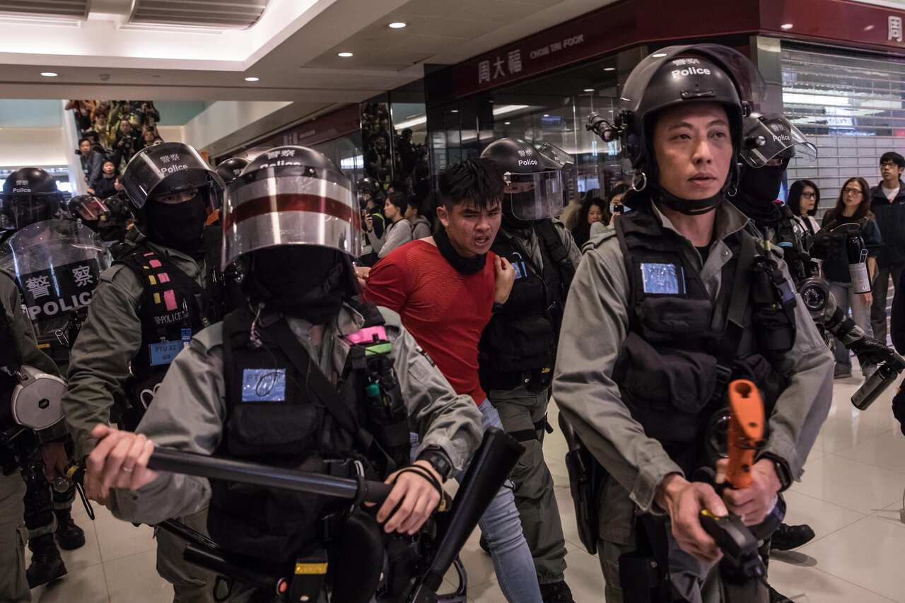 Riot police detain a man (C) after a pro-democracy protest inside a shopping mall in Sheung Shui, Hong Kong.