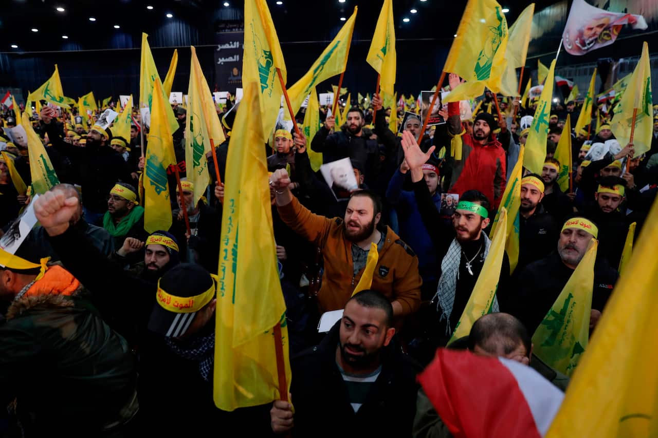Supporters of the Hezbollah movement wave flags in Beirut.