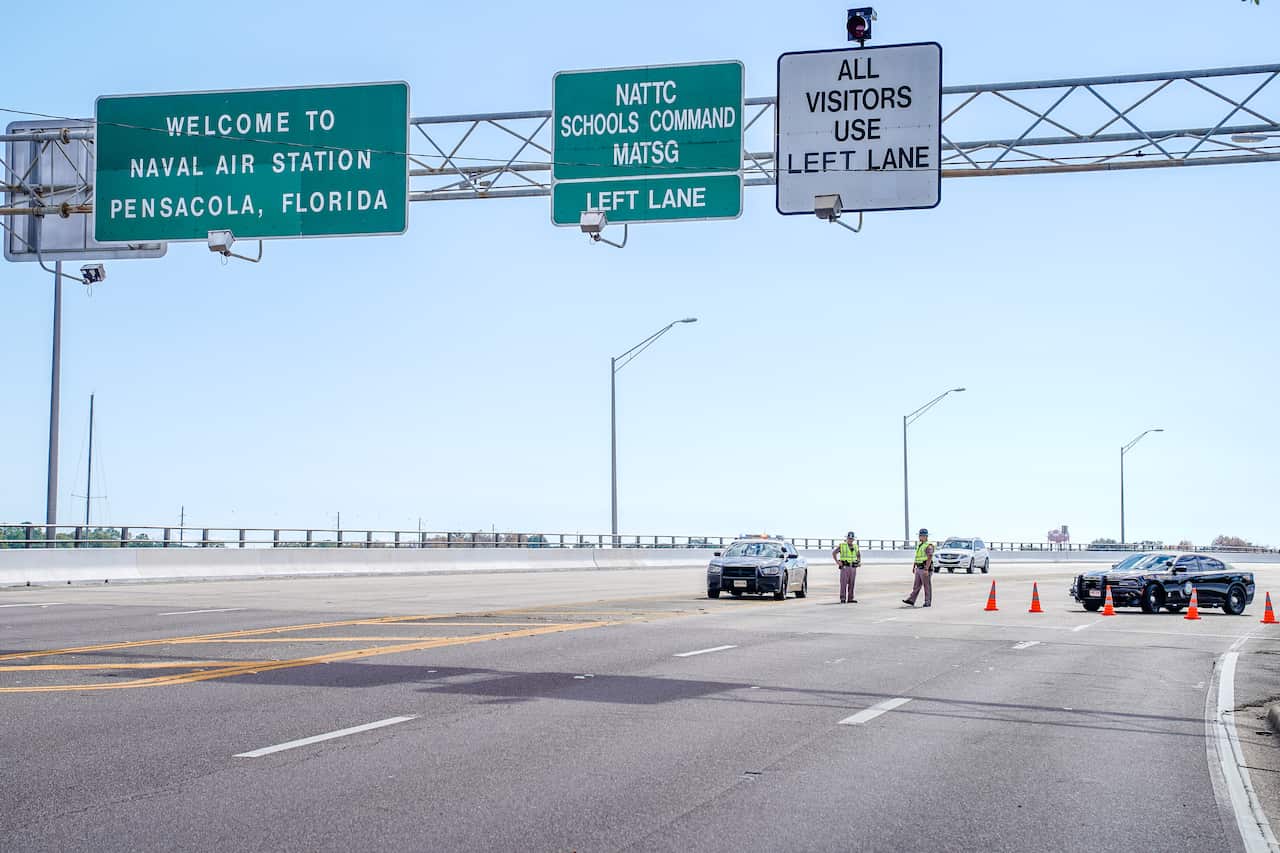 Florida State Troopers block traffic over the Bayou Grande Bridge leading to the Pensacola Naval Air Station.