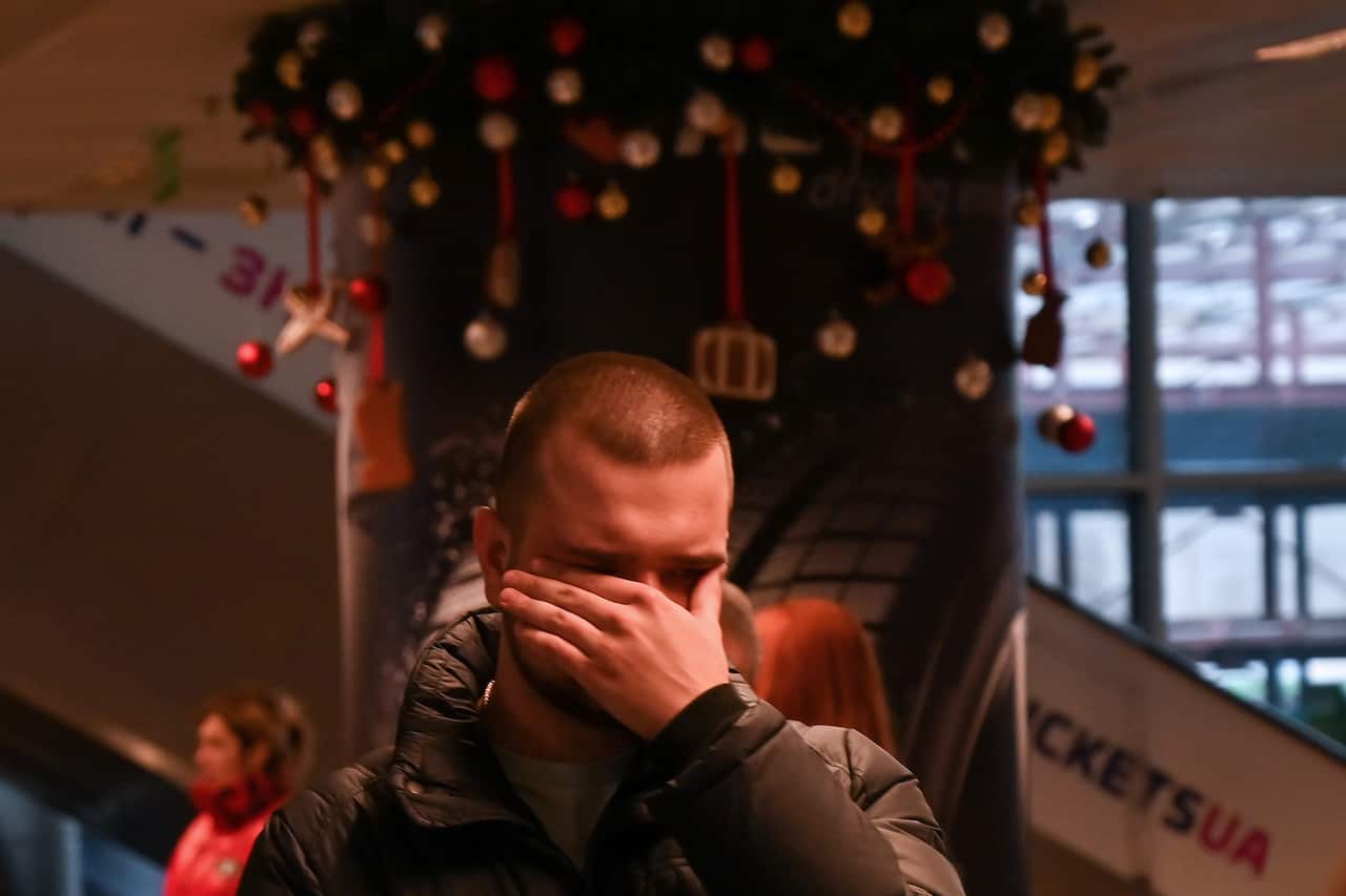 A relative of passengers and crew members of the crashed Ukraine International Airlines Flight PS752 reacts at the Boryspil airport outside Kiev.