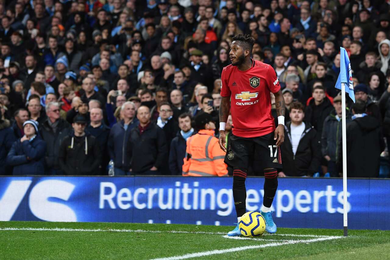Fred of Manchester United takes a corner kick after being hit by objects thrown by the Manchester City fans during the Premier League derby at Etihad Stadium.