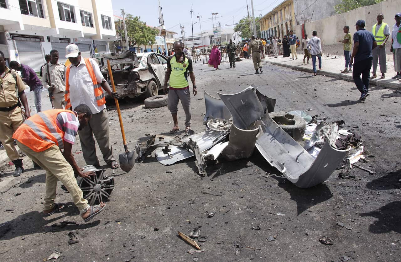 Damaged vehicles are seen after a car bombing near the Somali parliament building.