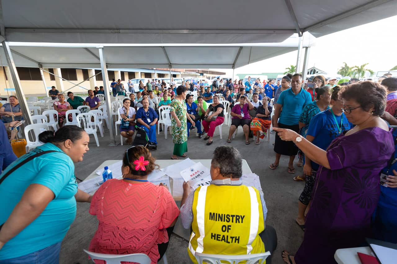 Health officials address the outbreak with locals.