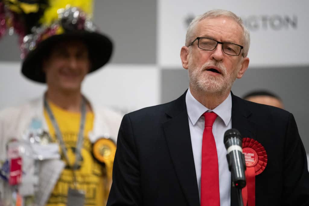 Labour Party leader Jeremy Corbyn (R) addresses the media and supporters after retaining his parliamentary seat.