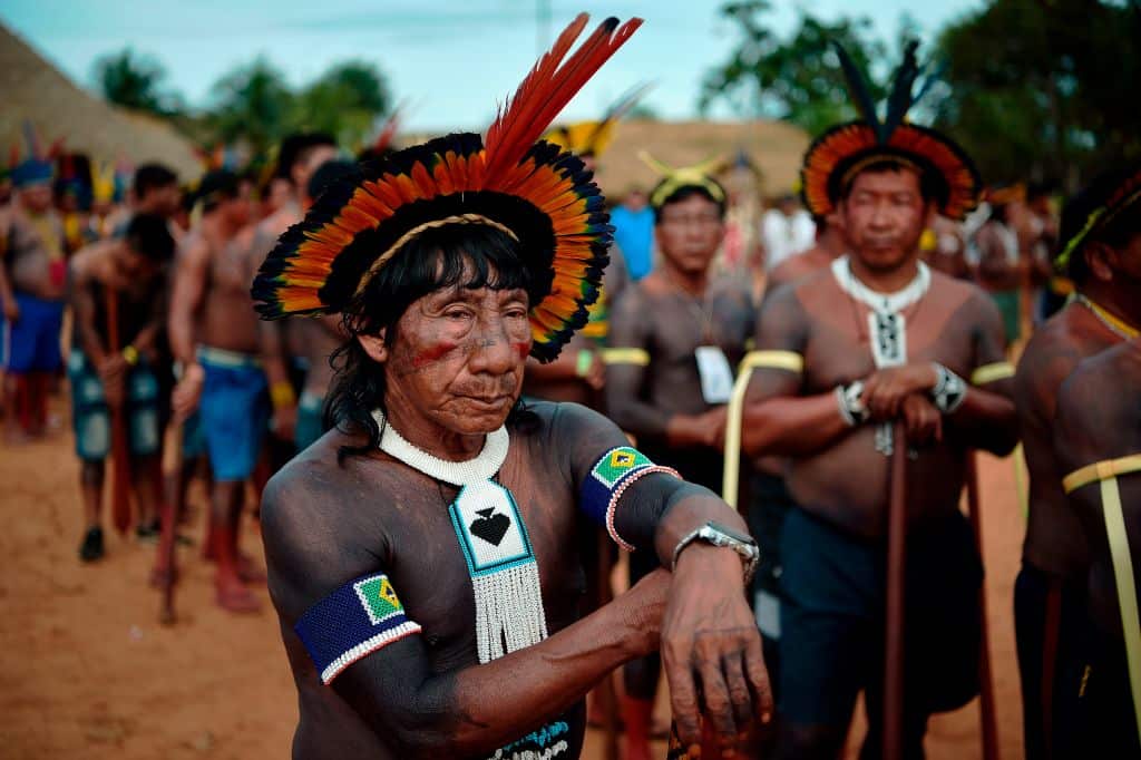 Members of the Kisejde tribe wait to perform a ceremonial dance for their leader Cacique Raoni Metuktire of the Kayapo tribe, in Piaracu village