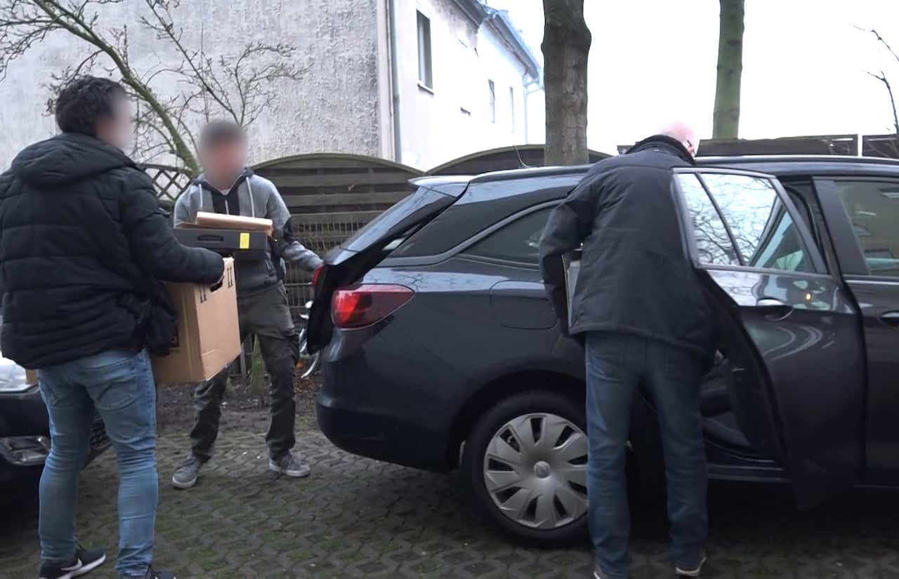 German policemen raid a home in connection with the ban of the neo-Nazi group Combat 18.
