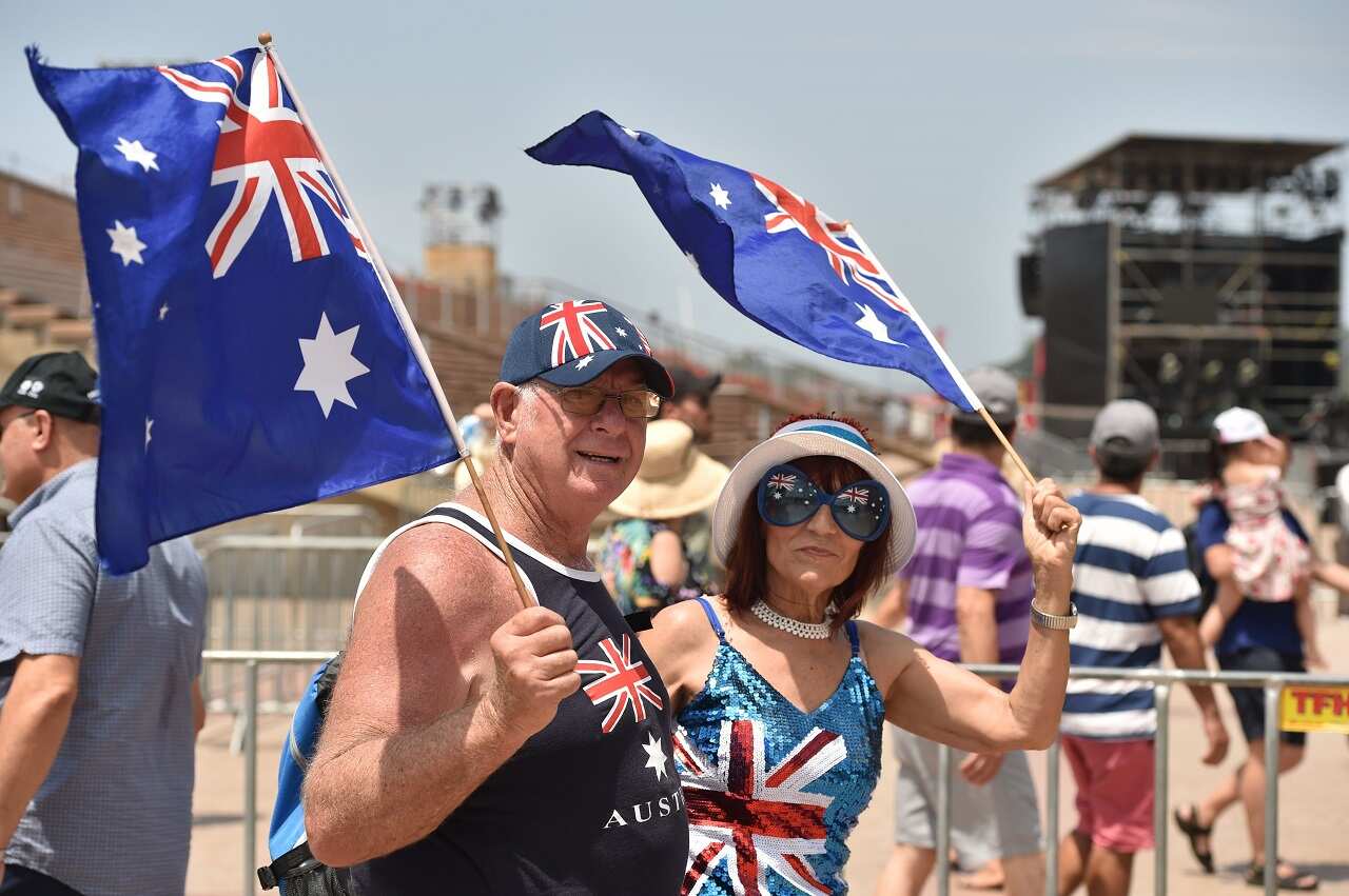 People wave flags to celebrate Australia Day.
