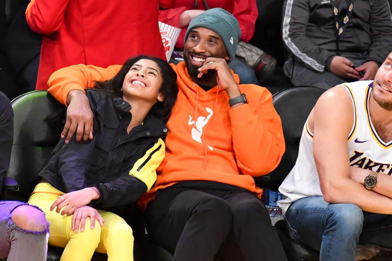 Kobe Bryant and his daughter Gianna attend a basketball game between the Los Angeles Lakers and the Dallas Maverick in 2019.