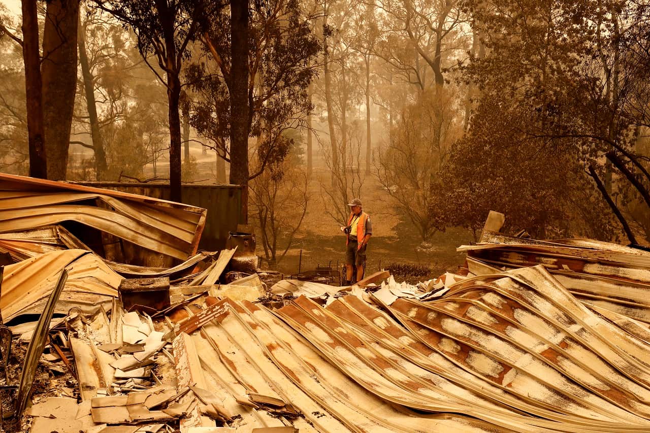 Sarsfield resident Wayne Johnston inspects damage to his property on 3 January.
