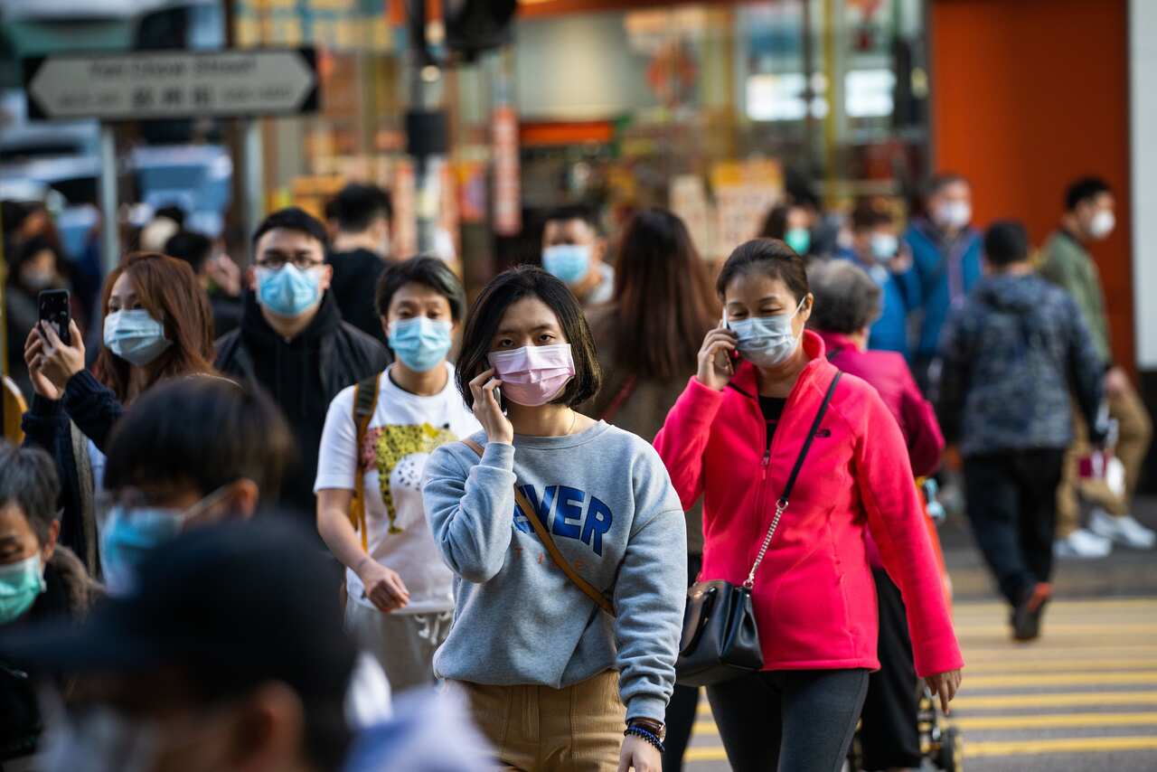 Residents seen wearing surgical masks while crossing the