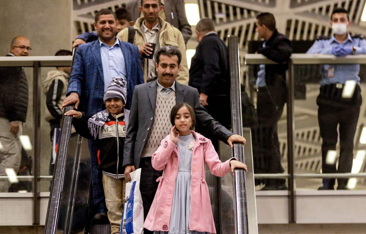 Yemeni children and their guardians arrive after a UN medical evacuation from Sanaa at Queen Alia International Airport, south of the Jordanian capital Amman.