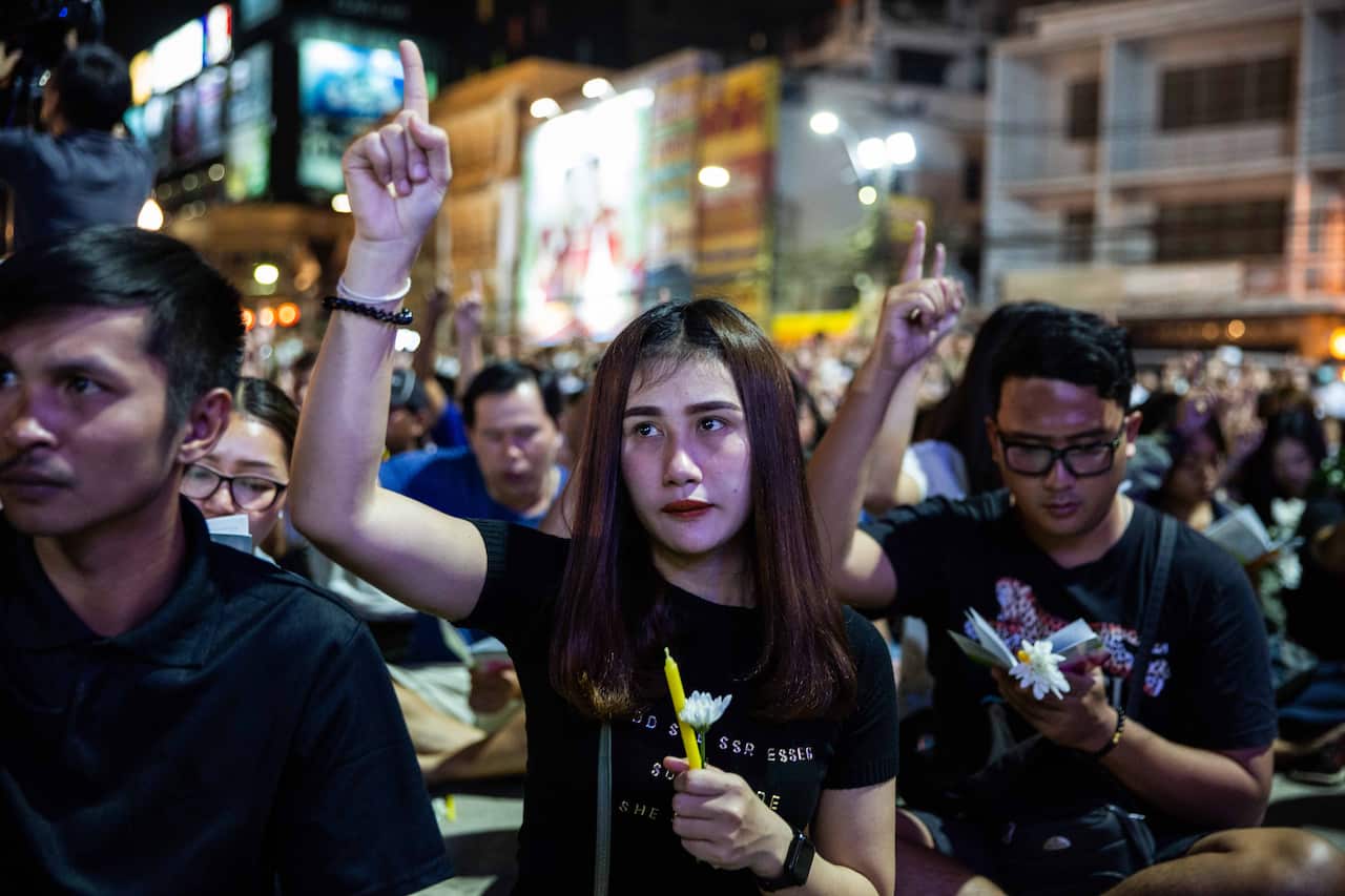 Thai mourners attend a candlelight vigil for the victims of the Terminal 21 Mall shooting on 9 February, 2020 in Korat, Thailand.