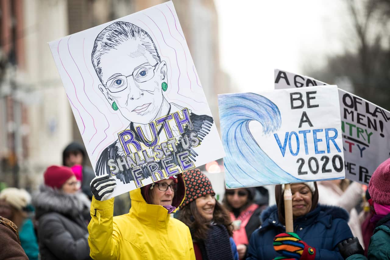 A marcher holds a sign that says "Ruth Shall Set Us Free" during the Woman's March in NY in January 2020.