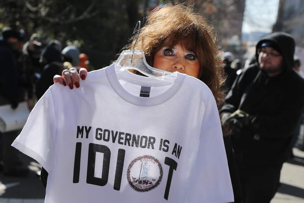 A vendor sells t-shirts on the street outside a gun rights rally organized byThe Virginia Citizens Defense League.
