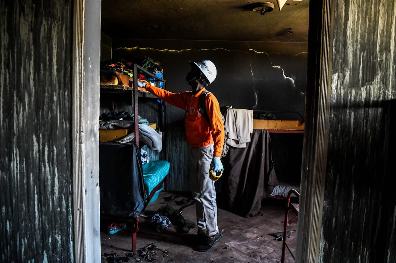A fireman inspects a room inside the Orphanage of the Church of Bible Understanding.