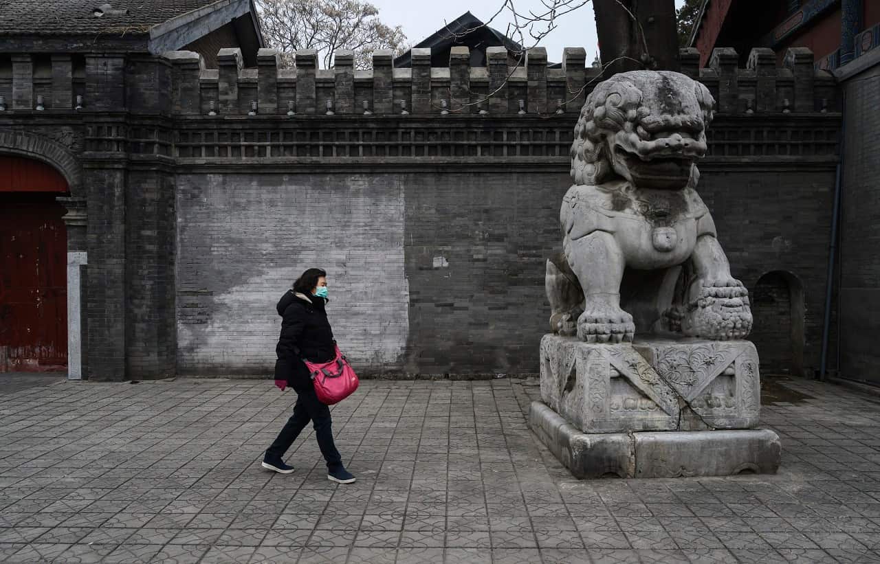 A Chinese woman wears a protective mask in Beijing.