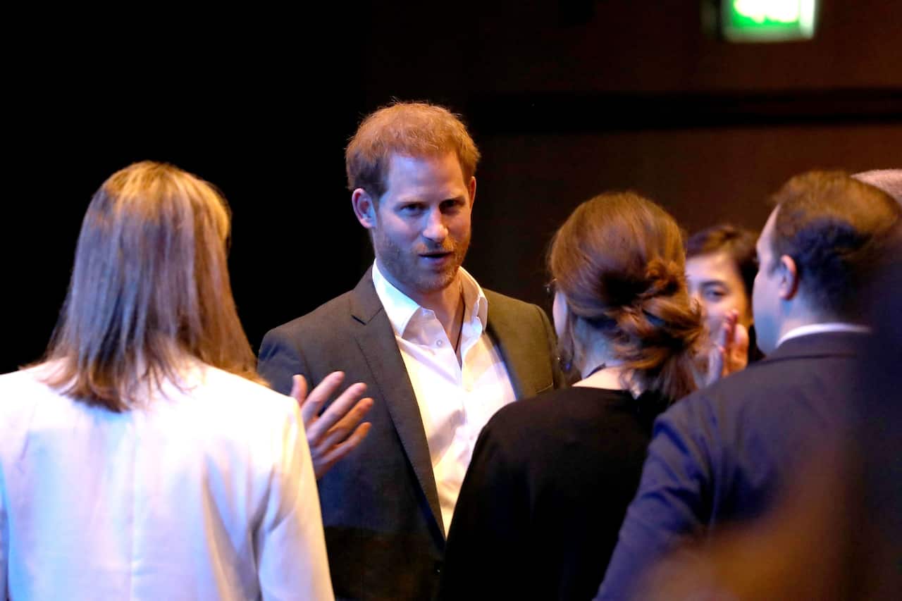Prince Harry, Duke of Sussex, greets guests at the sustainable tourism summit.