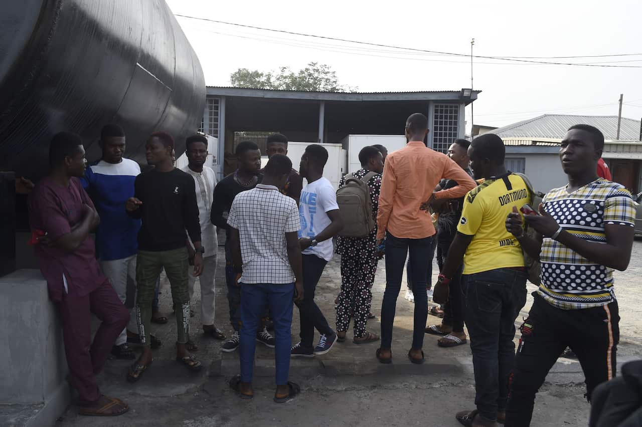 Some of the young men being prosecuted for homosexuality stand at the premises of the Federal High Court in Lagos.