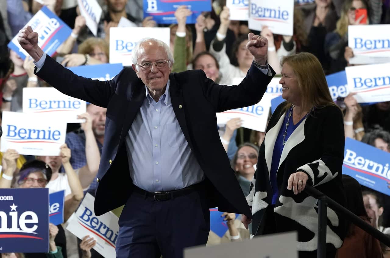 Democratic presidential hopeful Vermont Senator Bernie Sanders accompagnied by his wife Jane O'Meara Sanders arrives during a 2020 Super Tuesday Rally.