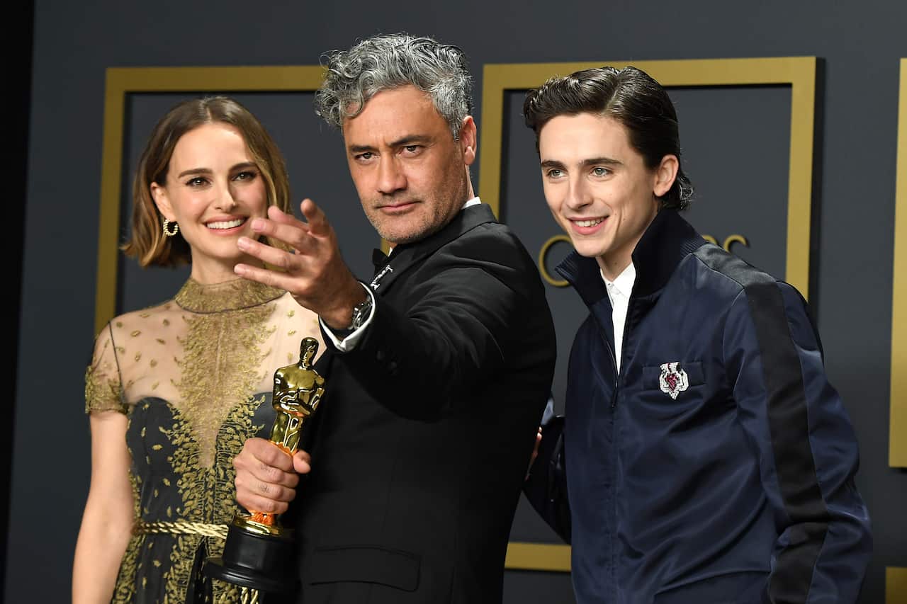Natlie Portman, Taika Waititi, winner of the Adapted Screenplay award for Jojo Rabbit  and Timothee Chalamet pose in the press room.