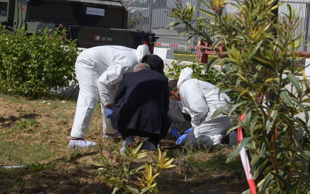 Forensic experts investigate at the scene of an explosion 