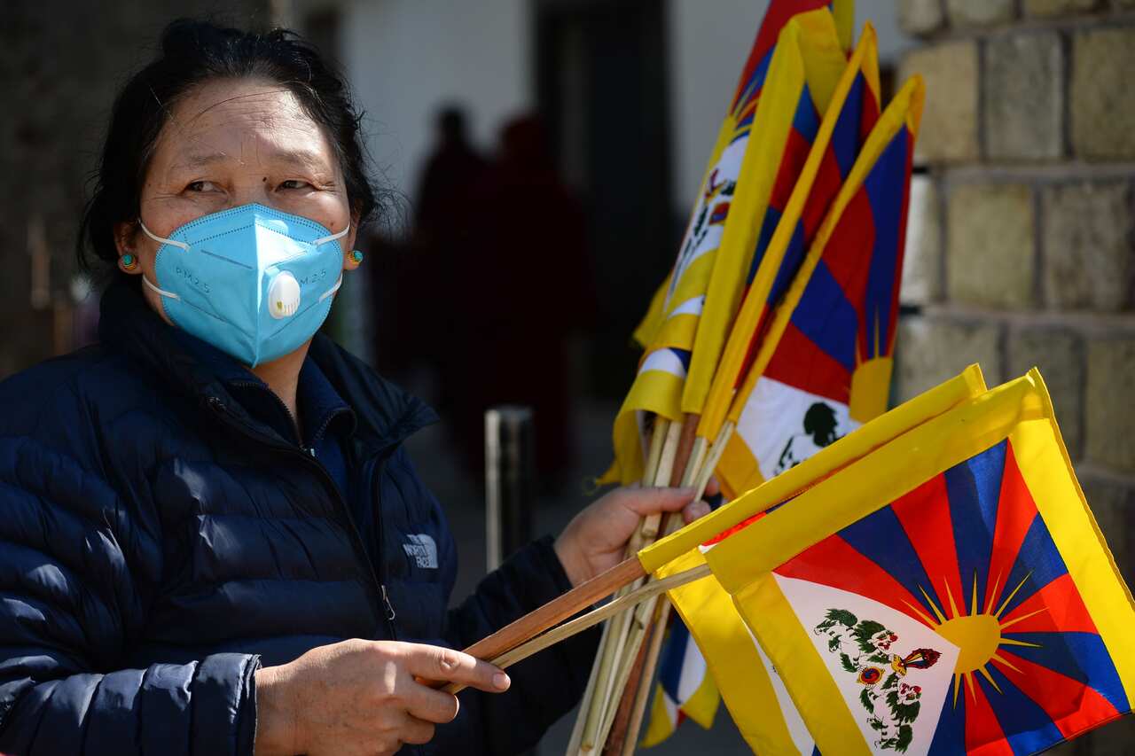 A woman with Tibetan flags at a street market in McLeod Ganj, India, earlier this year. 