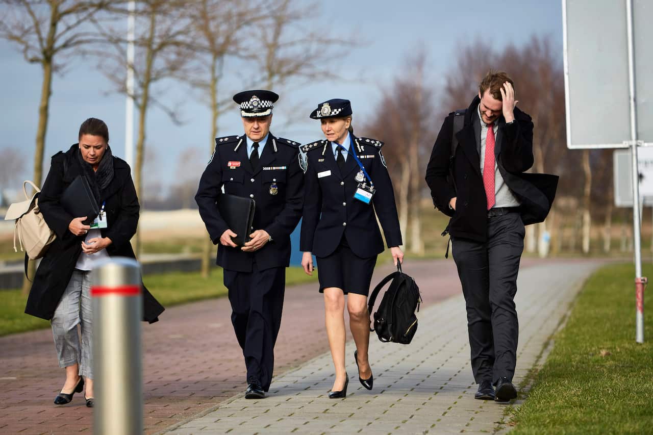 Officers of the Australian Federal Police walk outside the tribunal of Schiphol.
