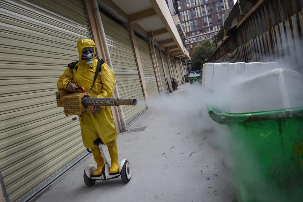 A medical staff member sprays disinfectant at a residential area in Wuhan in China's central Hubei province