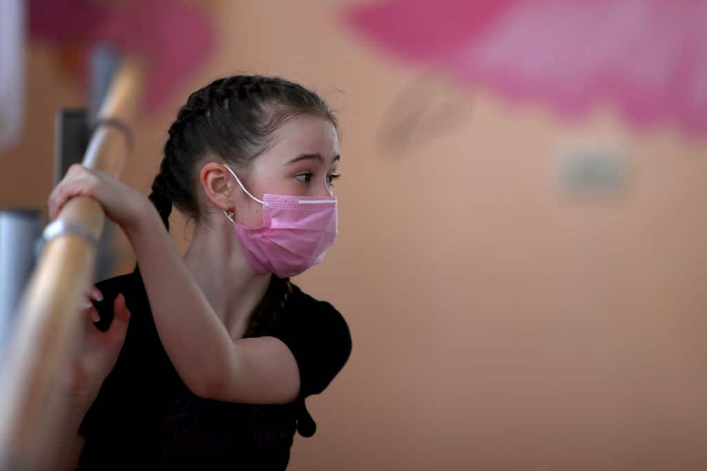 A girl wearing a face mask during a class at a dance studio during the COVID-19 pandemic