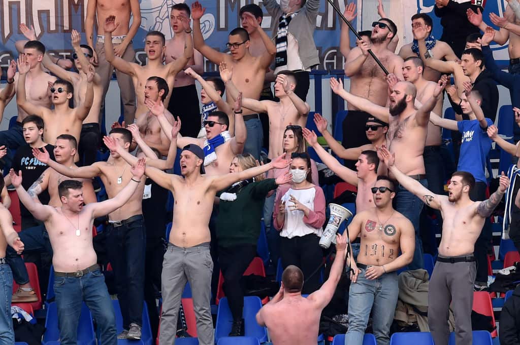 Fans of FC Minsk support their team during the Belarus Championship foolball match 
