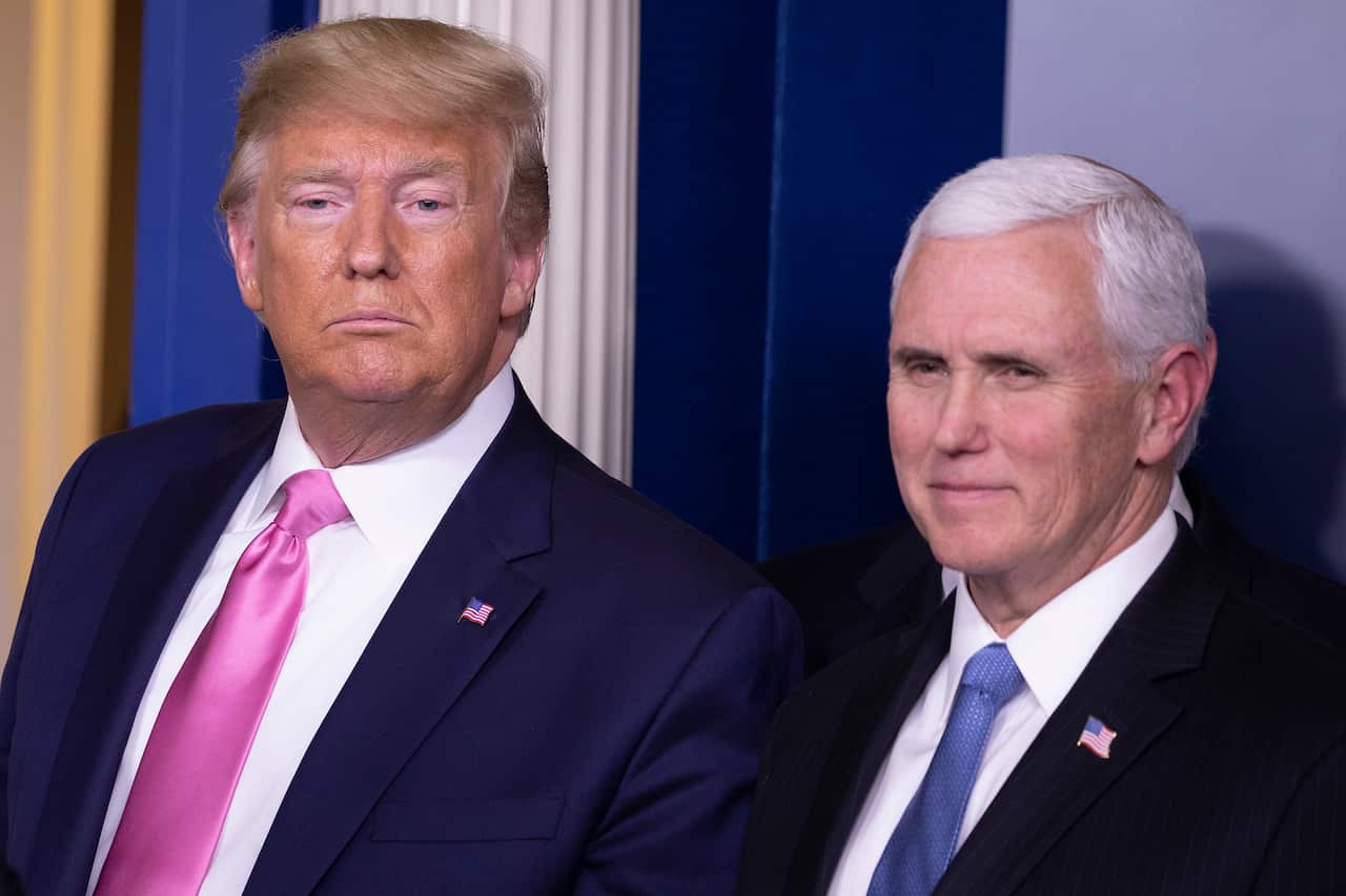 U.S. President Donald Trump looks on after a news conference with Vice President Mike Pence.
