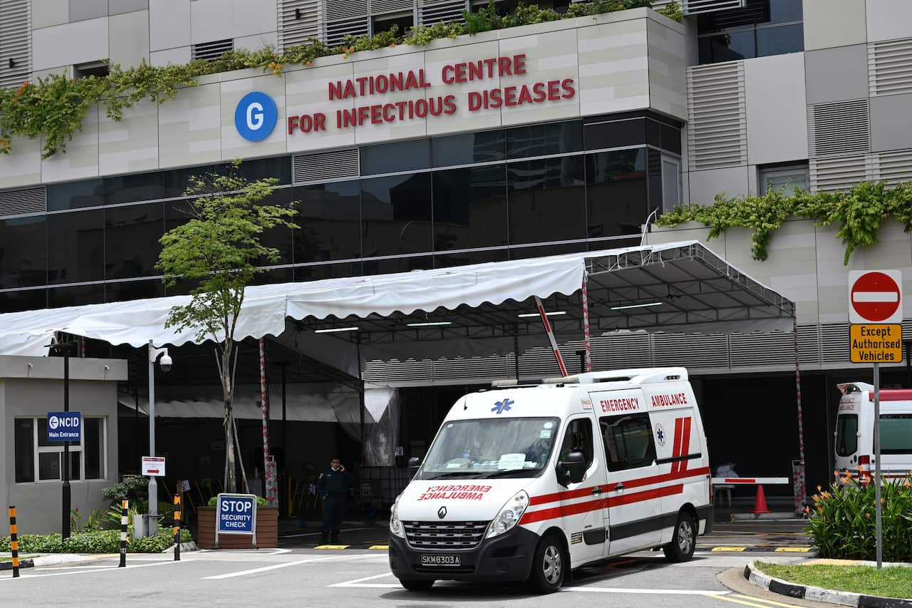 An ambulance leaves the National Centre for Infectious Diseases, where patients suffering from the COVID-19 novel coronavirus are being cared for, in Singapore on April 3, 2020. (Photo by Roslan RAHMAN / AFP) (Photo by ROSLAN RAHMAN/AFP via Getty Images)