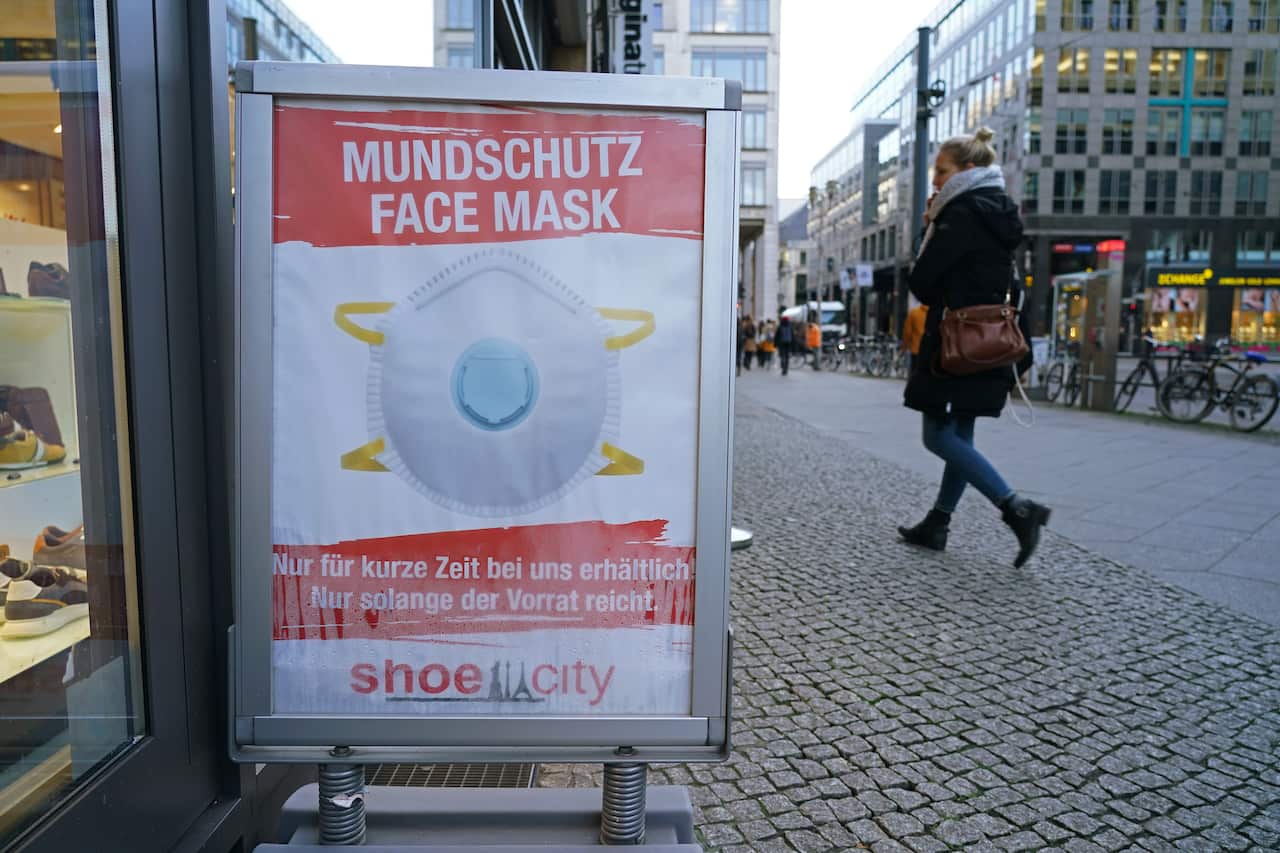 A shoe store in Berlin, Germany advertises protective face masks for sale.