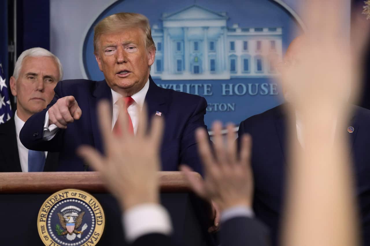 U.S. President Donald Trump takes questions as Vice President Mike Pence looks on during a news conference at the James Brady Press Briefing Room.