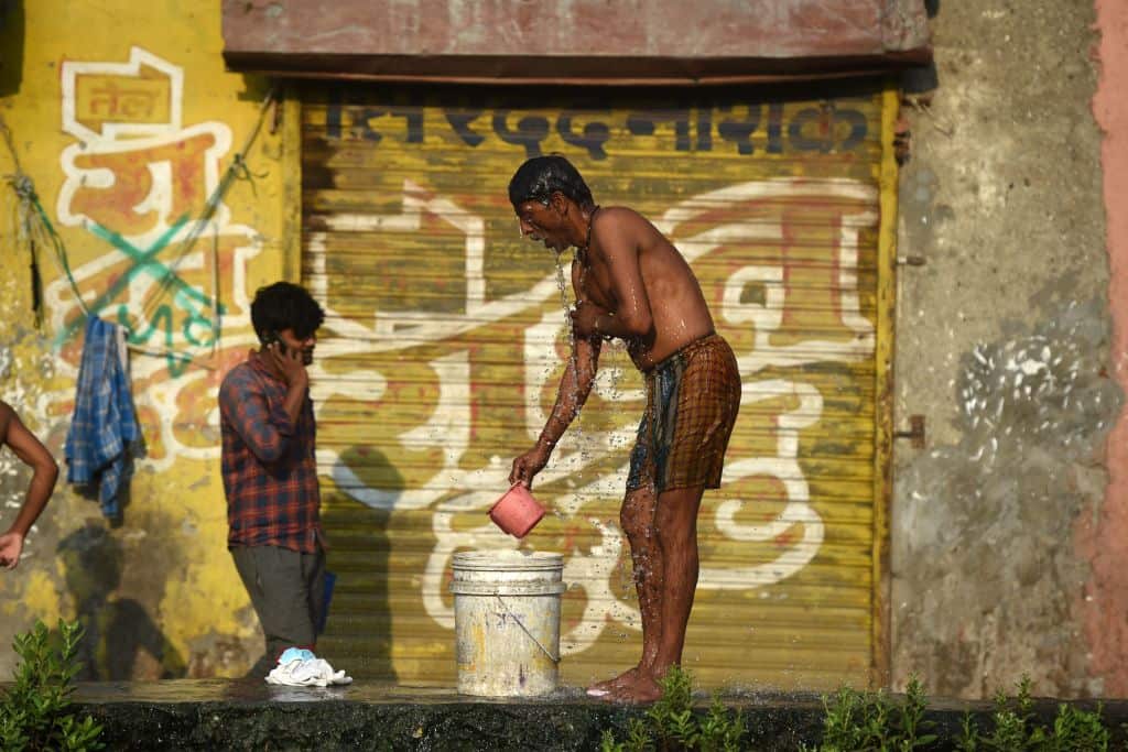 A man bathes in the Dharavi slum during the government-imposed nationwide lockdown 