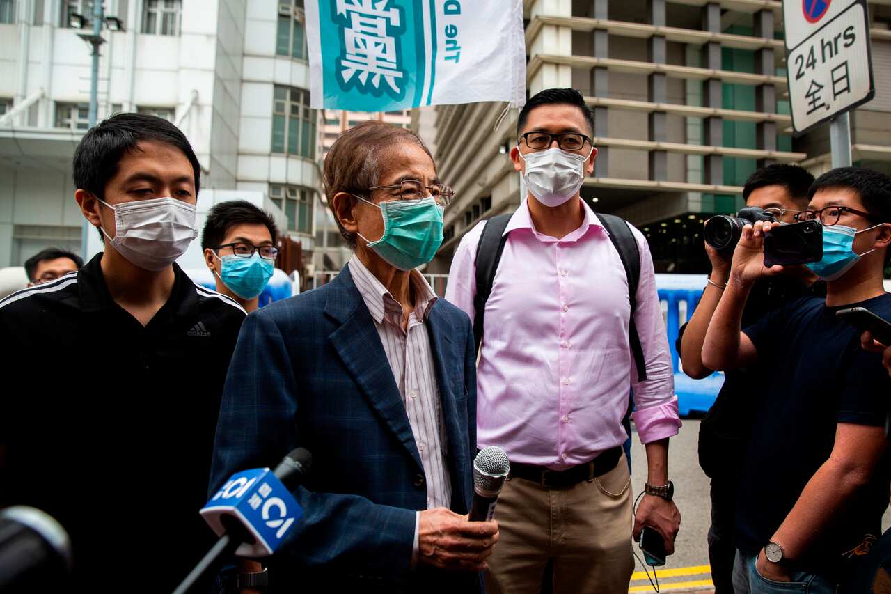 Former lawmaker and pro-democracy activist Martin Lee talks to the media as he leaves the Central District police station in Hong Kong.