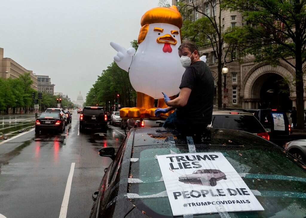 Protesters driving in the motorcade stop at the Trump International Hotel
