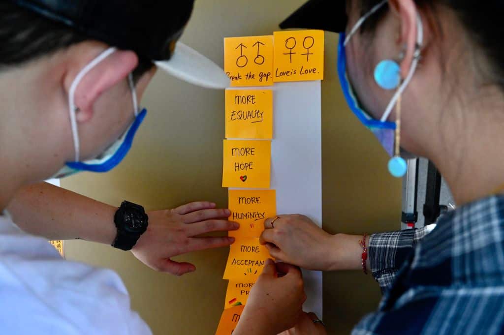 People paste notes on a 'Lennon Wall' in front of the Presidential Office in Taipei on May 17, 2020