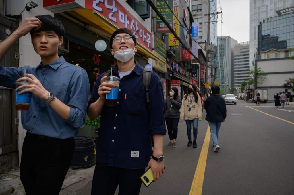 Office workers walk along a street during the lunch period in central Seoul 