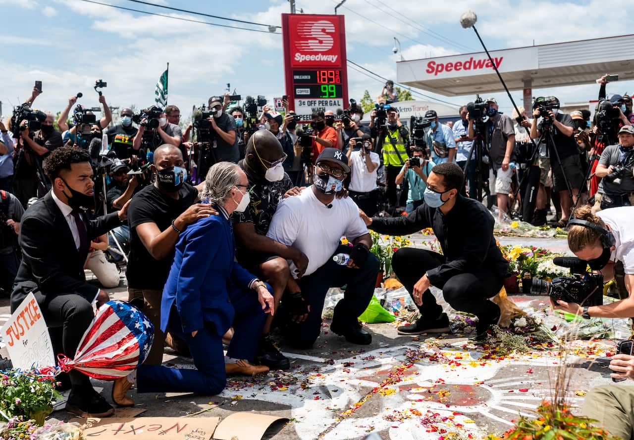 Terrence Floyd knelt to pray at the spot where his brother died one week earlier.
