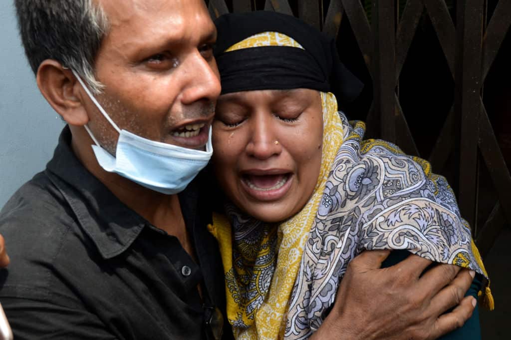 Relatives of a victim of a ferry capsized mourn as rescue workers unload bodies in Dhaka, Bangaldesh.
