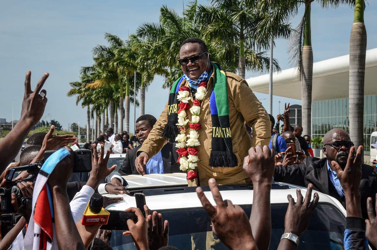 Tundu Lissu reacts to supporters as he returns after three years in exile to challenge President John Magufuli, at Julius Nyerere International Airport in July.