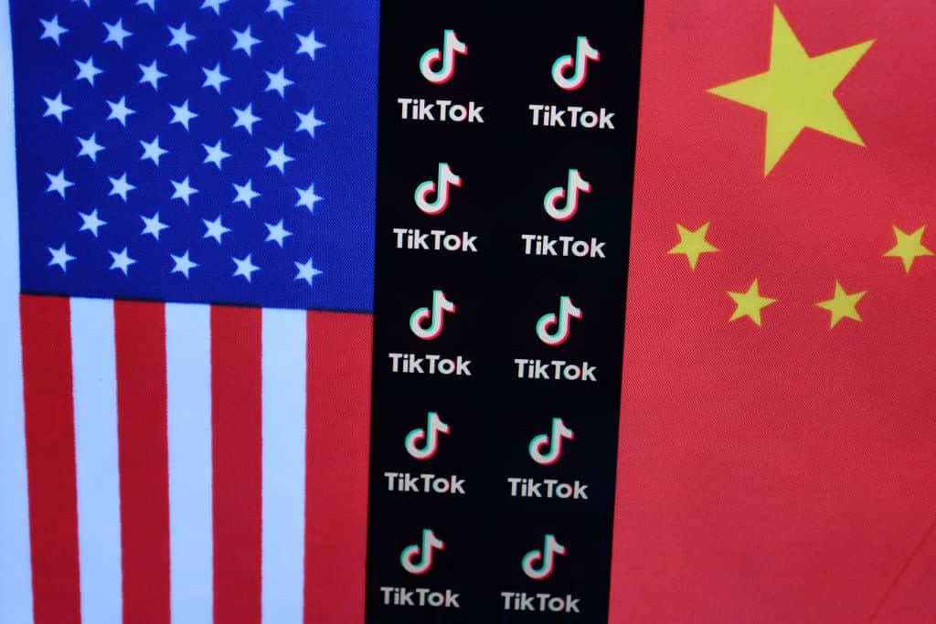 TikTok logo is seen displayed between US and China flags