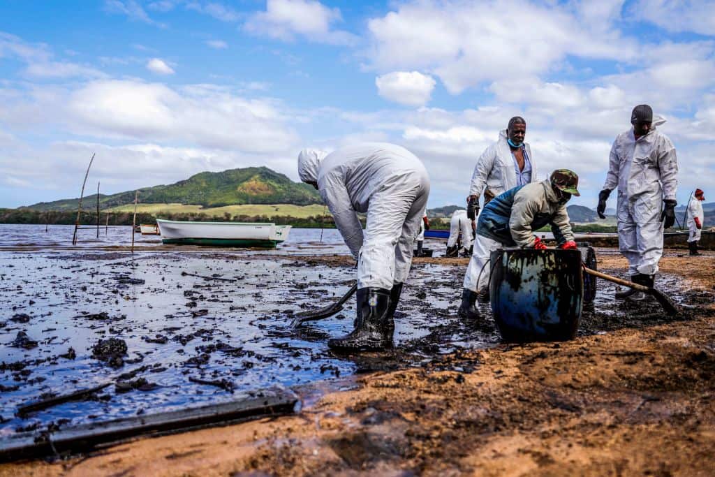 People scoop leaked oil from the vessel MV Wakashio that ran aground and caused oil leakage near Blue bay Marine Park in southeast Mauritius.