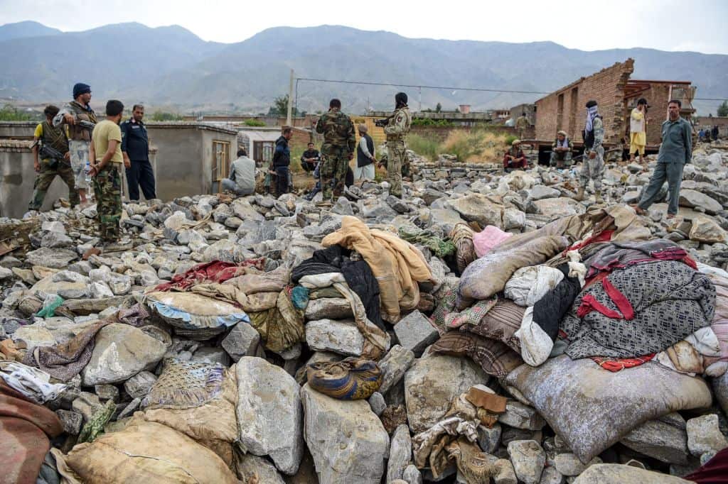 Villagers and security personnel gather after a flash flood affected the area at Sayrah-e-Hopiyan in Charikar.