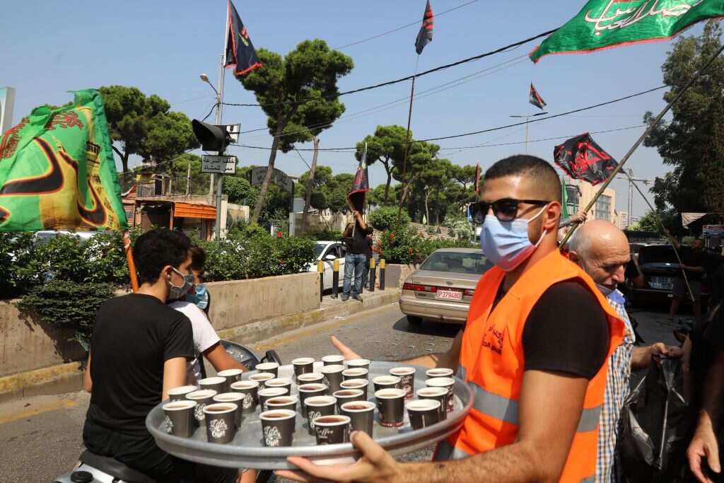 A young Lebanese Shiite Muslim man distributes coffee to passers-by during Ashura in Karbala, Iraq.