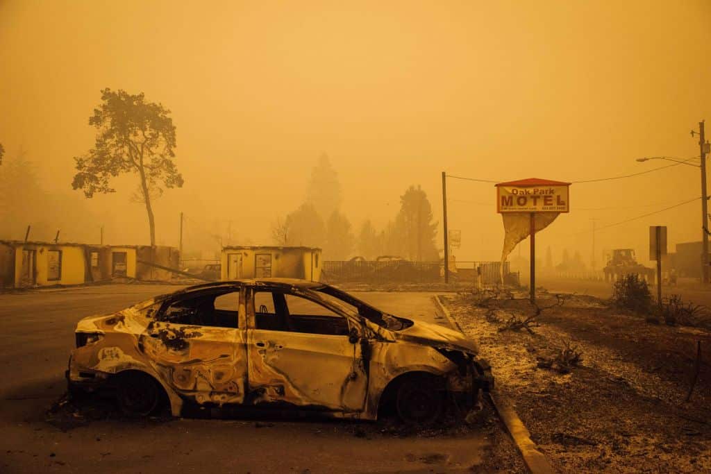A charred vehicle is seen in the parking lot of the burned Oak Park Motel after the passage of the Santiam Fire in Gates, Oregon, on 10 September, 2020.